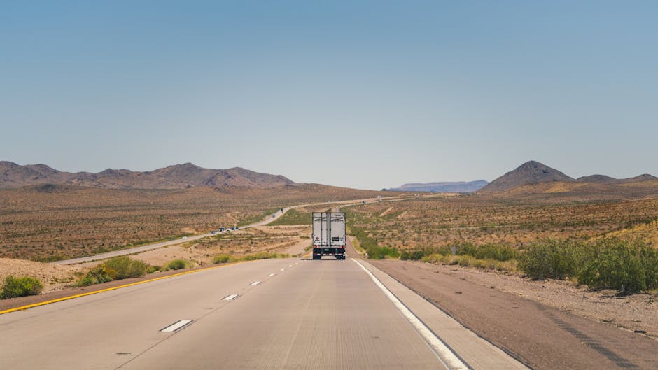Rolling Through the Canyon: A Truck on the Highway Near Grand Canyon’s Majestic Edge